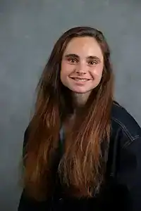 Young woman smiling, promoting awareness and support for eating disorder recovery.