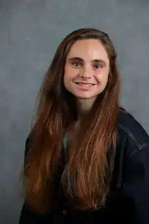 Young woman smiling, promoting awareness and support for eating disorder recovery.