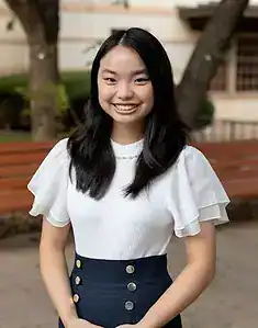 Young woman smiling outdoors, promoting awareness about eating disorders and mental health support.