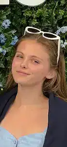 Young woman with sunglasses outdoors promoting awareness for eating disorders.