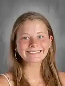 Young woman smiling, raising awareness for eating disorder recovery and support.