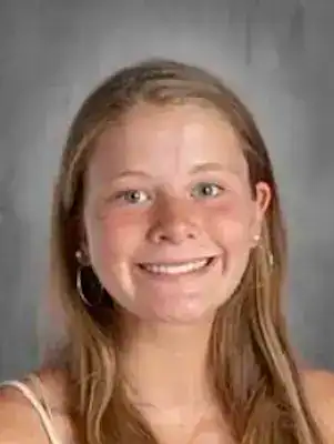 Young woman smiling, raising awareness for eating disorder recovery and support.